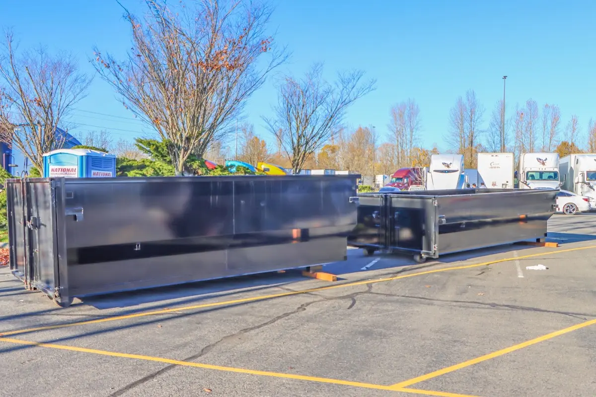 Professional dumpster rental service with roll-off container on residential driveway in Pico Rivera